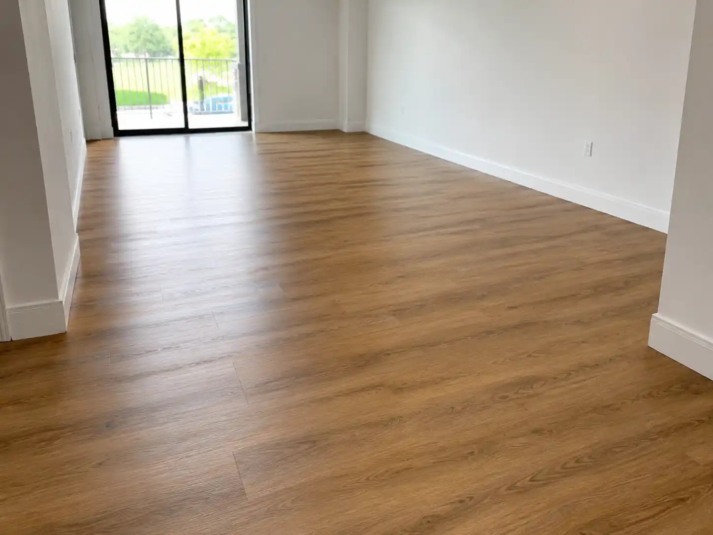 Completed flooring and finishing project featuring bright room flooring & trim finish